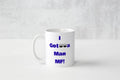 A white ceramic coffee mug with blue text reading 'I Got a Man MF!' printed on the side, set against a light gray textured background.